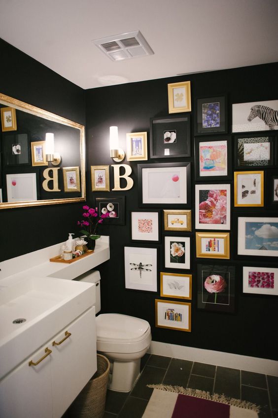 dark moody powder room with gallery wall
